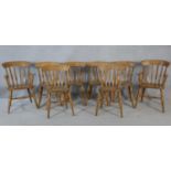 A set of eight 19th century fruitwood stick back dining chairs with moulded seats on turned