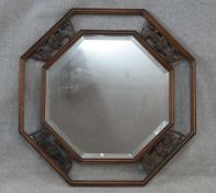 An Eastern teak bevelled plate wall mirror with Chinese bat carvings to the open fretwork frame. H.