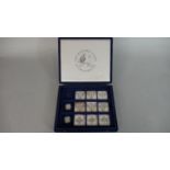 A box of eleven silver proof pound coins in capsules, nine with COA's in blue velvet partitioned