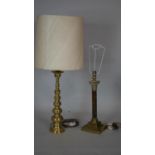 A brass Corinthian column table lamp base and an Eastern style brass table lamp and shade. H.51cm (