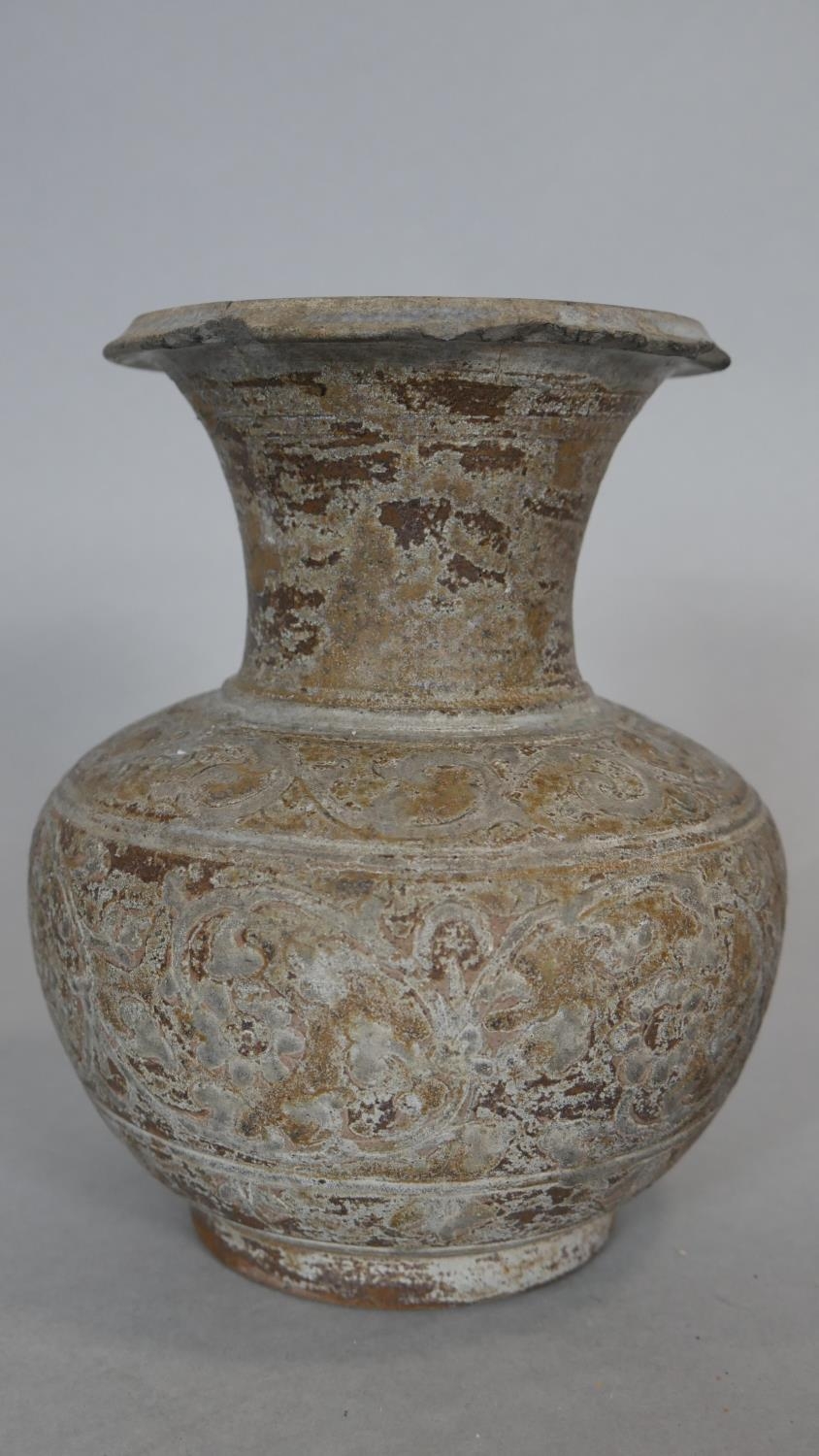 An Oriental ceramic glazed flared neck vase with stylised floral design. H.16.5cm