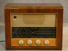 A vintage Bush walnut cased radio. With makers label. H.39 L.50 W.22cm