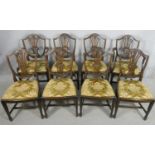 A set of eight Hepplewhite style mahogany dining chairs with carved and pierced back splats above