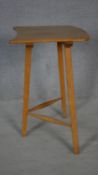 A mid century vintage Ercol blonde elm and beech tripod table with maker and retailer's labels