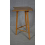 A mid century vintage Ercol blonde elm and beech tripod table with maker and retailer's labels