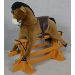 A vintage style Merrythought plush fabric rocking horse on a swing stand. H.98 L.108cm