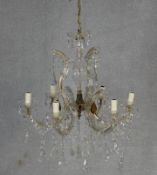 A vintage gilt metal and glass six branch chandelier with crystal drops and swags. W.60cm