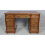 A late 19th century oak pedestal desk with tooled inset leather top and original brasswork on a