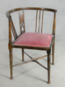 A late Victorian beech framed corner chair on circular tapering pad foot supports with maker's label