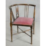 A late Victorian beech framed corner chair on circular tapering pad foot supports with maker's label