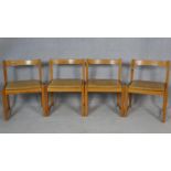 A set of four vintage pitch pine dining chairs with light tan leather upholstered seats. H.75cm