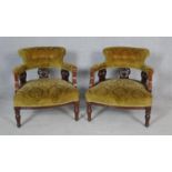 A pair of late Victorian carved mahogany framed tub armchairs in cut floral velour upholstery on
