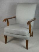 A mid century vintage Parker Knoll beech framed upholstered and sprung easy armchair with maker's