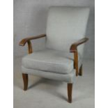 A mid century vintage Parker Knoll beech framed upholstered and sprung easy armchair with maker's