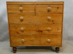 A Victorian pine chest of two short above three long drawers on turned tapering supports. H.100 W.97