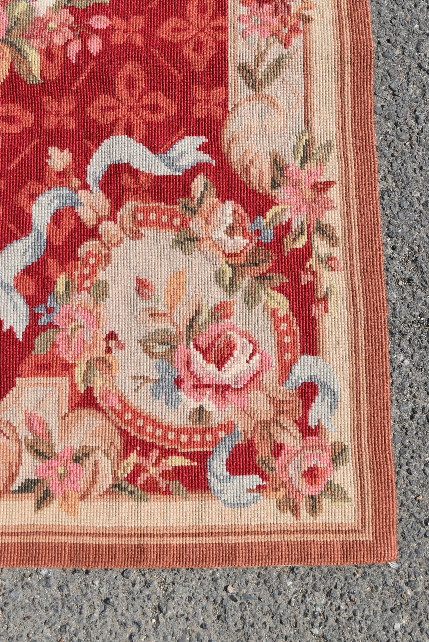 A needlepoint rug with central floral cartouche on a burgundy field within ribbon and flowerhead - Image 3 of 4