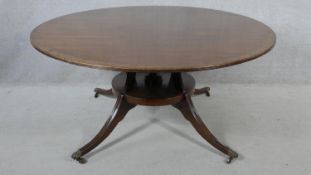 A Regency style mahogany and crossbanded dining table on swept quadruped platform base. H.72 L.152.5