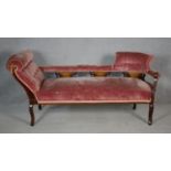 A late Victorian mahogany framed double end chaise longue in buttoned velour upholstery and with