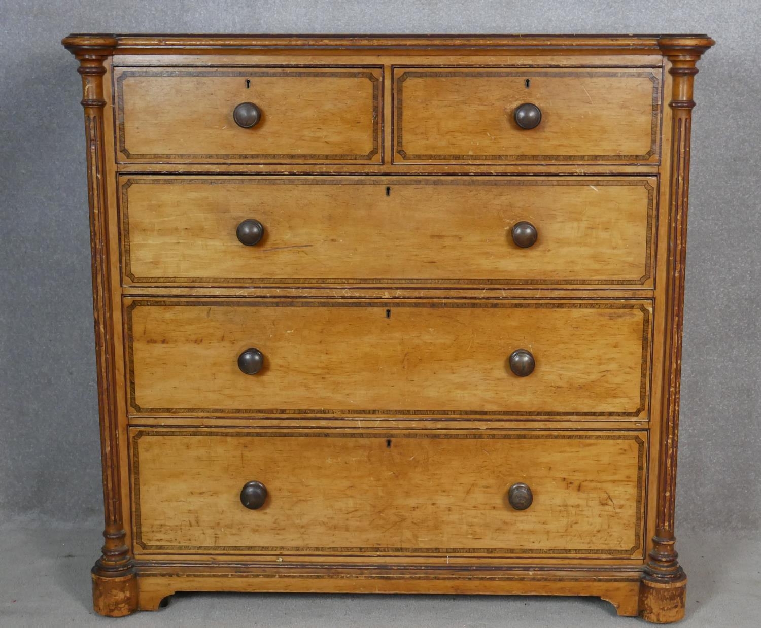 A late Victorian Aesthetic movement pitch pine chest of drawers with painted and ebonised decoration