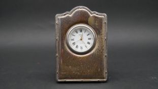 A velvet backed silver fronted easel desk clock by Richard Carr. White enamel dial, gilded