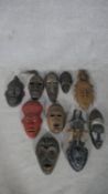 A collection of ten vintage wooden tribal masks. Various regions and tribes. Some are painted and