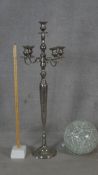 A large floor standing five branch chrome candelabra along with a crackle glass globe light filled