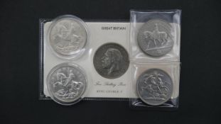 Five silver coins. Including a 1935 silver crown of George V in a presentation wallet, two 1935
