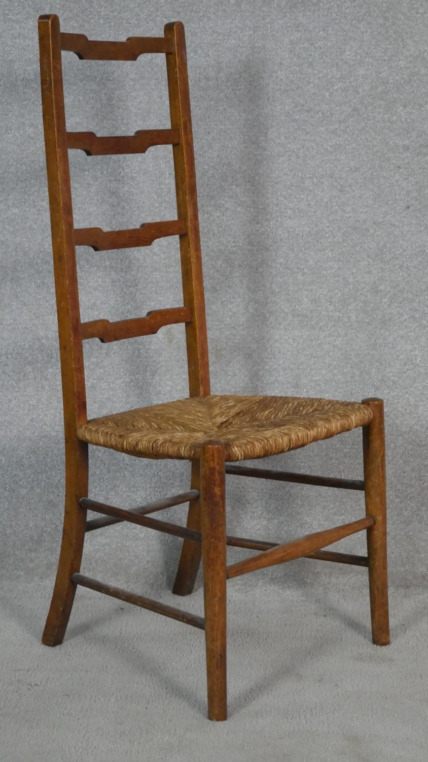 A pair of C.1900 oak ladderback chairs with woven rush seats on circular stretchered supports. H. - Image 3 of 5