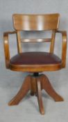 A mid century vintage teak swivel office desk chair with maker's plaques to the underside. H.83cm