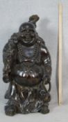 A large faux wood resin figure of a Chinese happy Buddha. H.88cm