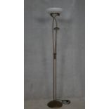 A metal framed uplighter with frosted glass shade and reading lamp extension. H.183cm