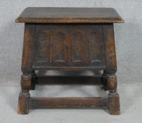 A 19th century oak Jacobean style joint stool with carved panelled coffer section on turned