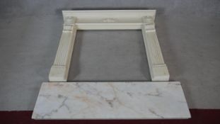 A faux polished marble fire surround in the Classical style with floral decorated frieze and