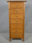 A contemporary pine narrow chest of seven drawers. H.120 W.52 D.42cm