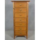 A contemporary pine narrow chest of seven drawers. H.120 W.52 D.42cm