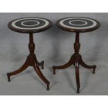 A pair of Colonial style occasional tables with carved and stained tops on tripod pedestal bases.