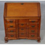 A 19th century Continental style fruitwood bureau with fully fitted interior on shaped squat bracket