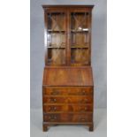 A Georgian style flame mahogany and crossbanded bureau bookcase with fitted interior. H.188 W.75 D.