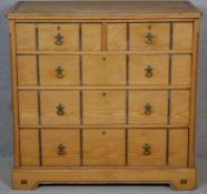 A late Victorian Aesthetic movement pitch pine chest of drawers with ebony and satinwood inlay and