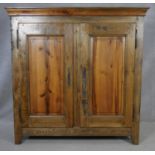 A 19th century style French Provincial elm armoire with panelled doors enclosing adjustable linen