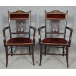 A pair of late Victorian rosewood armchairs with satinwood and ivory scrolling foliate urn inlay