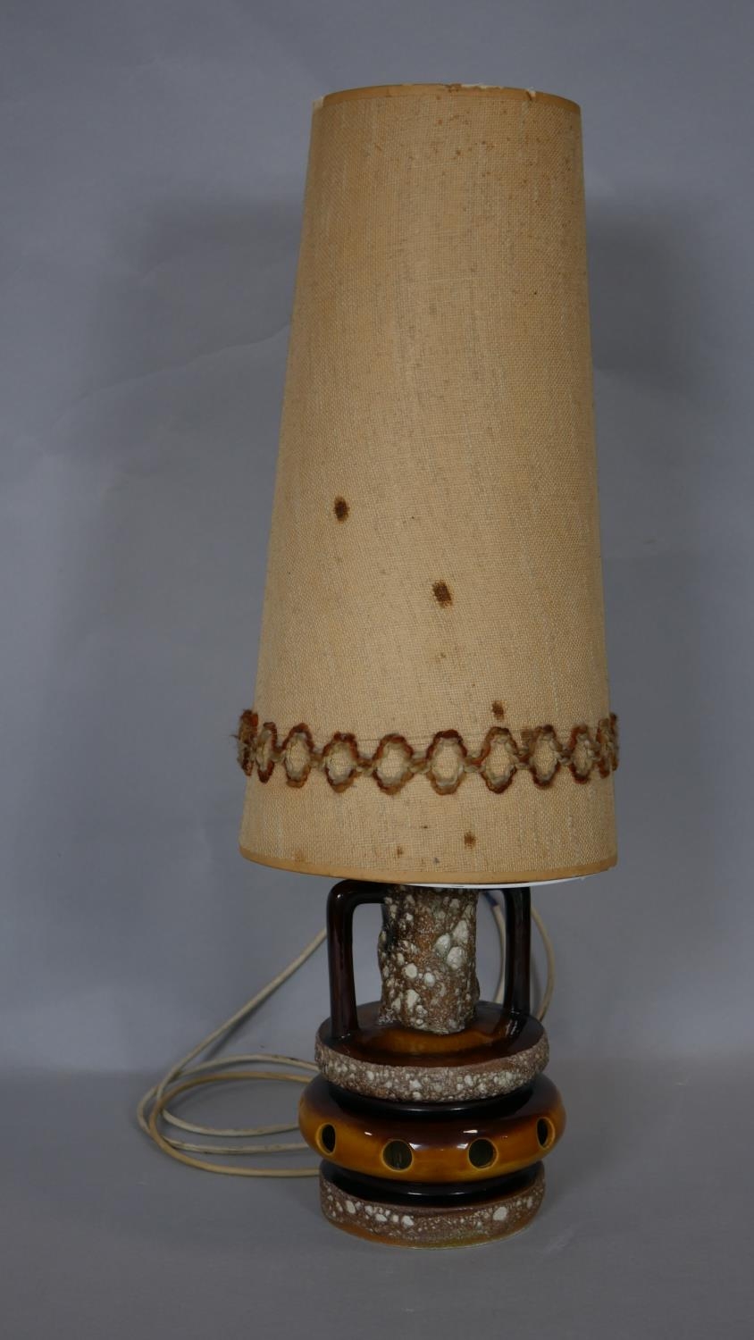 A vintage West German Pottery table lamp with fat lava glaze and its original woven shade. H.78cm (