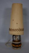 A vintage West German Pottery table lamp with fat lava glaze and its original woven shade. H.78cm (