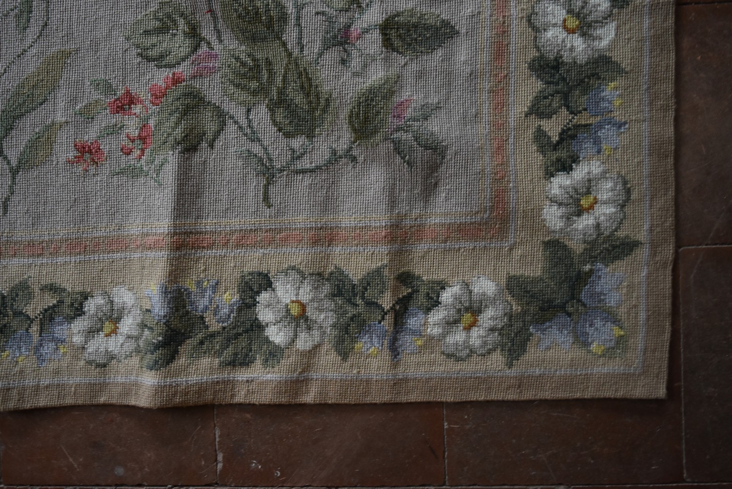 A needlepoint rug with foliate and wild flower sprays across a fawn field contained by garlands of - Image 3 of 4
