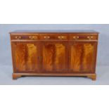 A Georgian style crossbanded and inlaid sideboard with inset figured mahogany panels. H.87 W.151 D.