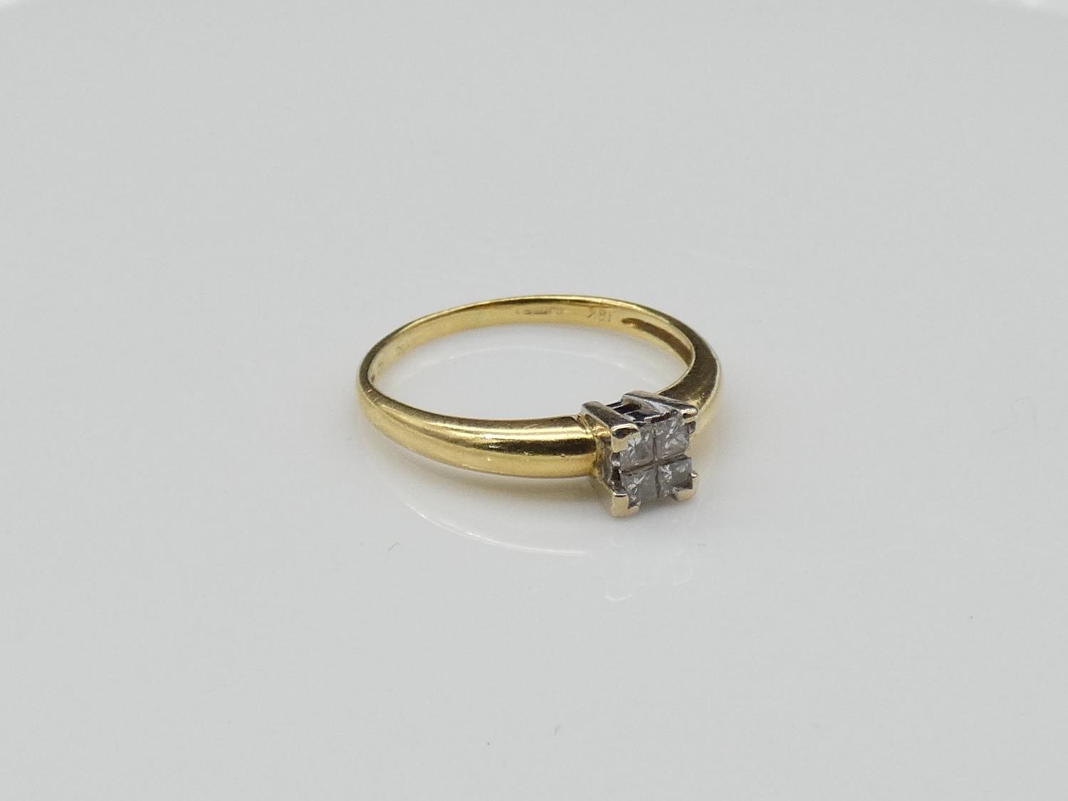 A vintage 18 carat yellow gold, platinum and diamond ring. Set with four square princess cut