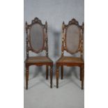 A pair of carved Carolean style side chairs with caned backs and seats on turned stretchered