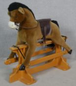 A vintage style Merrythought plush fabric rocking horse on a swing stand. H.98 L.108cm