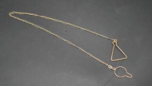 A 9 carat yellow gold antique fancy link chain with triangular fitting to one end and a circular