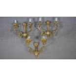 A set of three gilt metal twin branch wall sconces with scrolling arms and crystal drops. W.27cm